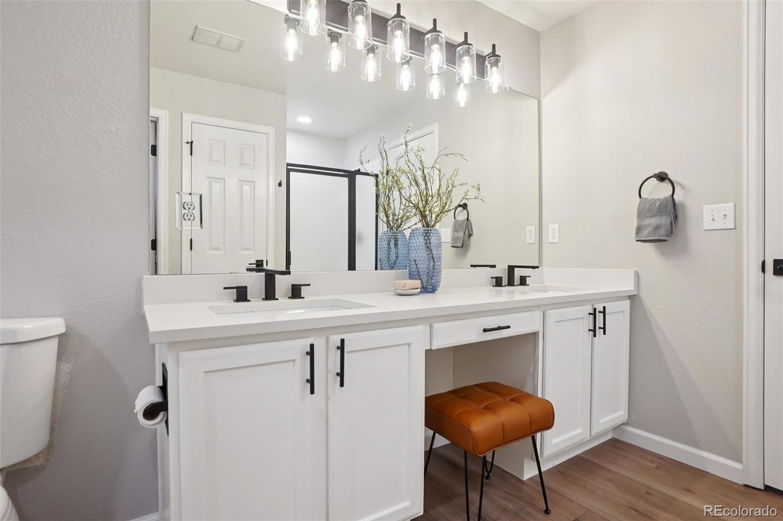 4271 South Blackhawk Circle, Unit 2C Aurora, CO 80014 - Photo 18 of 45 a bathroom with a sink vanity and a mirror