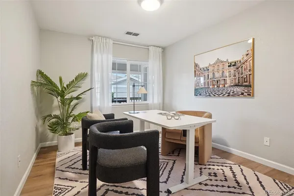 a view of a dining room with furniture window and wooden floor