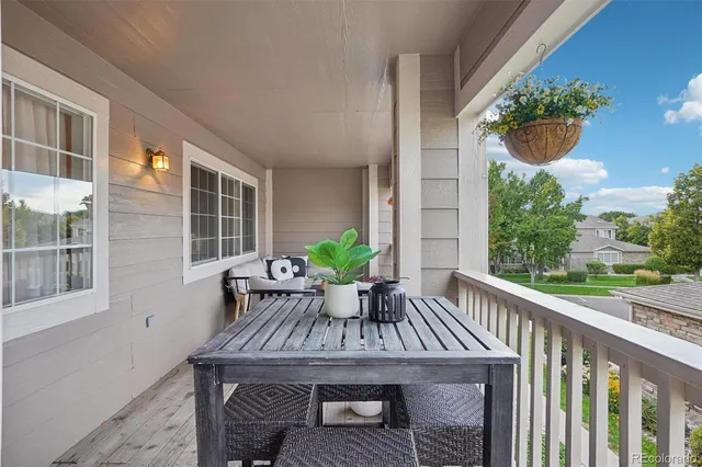 a view of balcony with furniture and garden