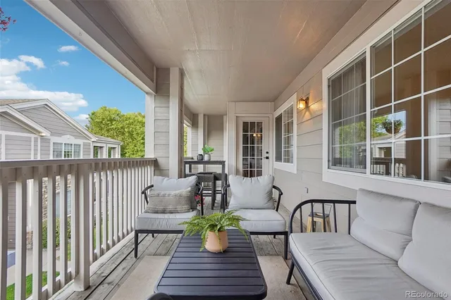 a balcony with furniture and a potted plant