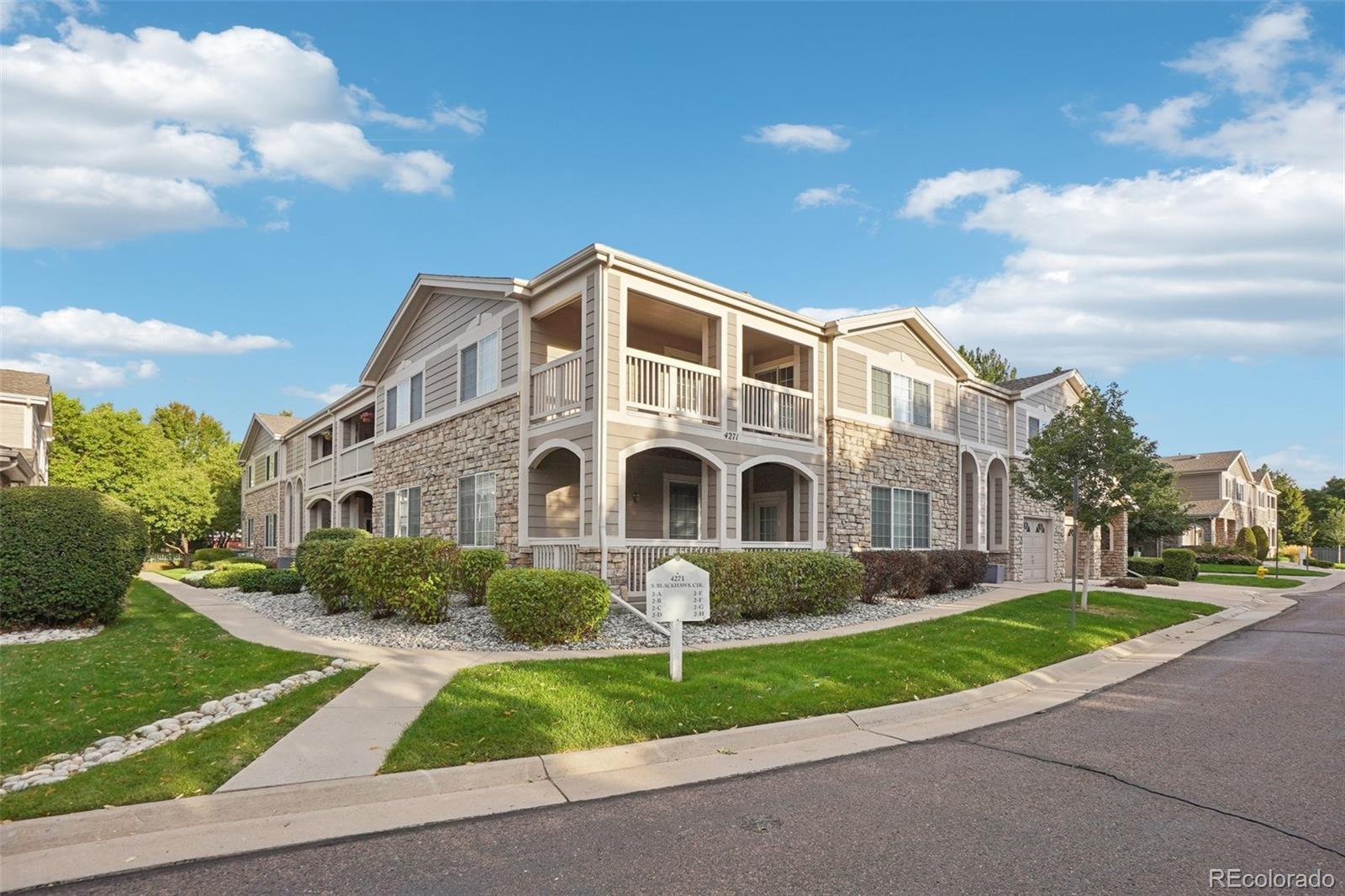 4271 South Blackhawk Circle, Unit 2C Aurora, CO 80014 - Photo 41 of 45 a front view of a house with a yard