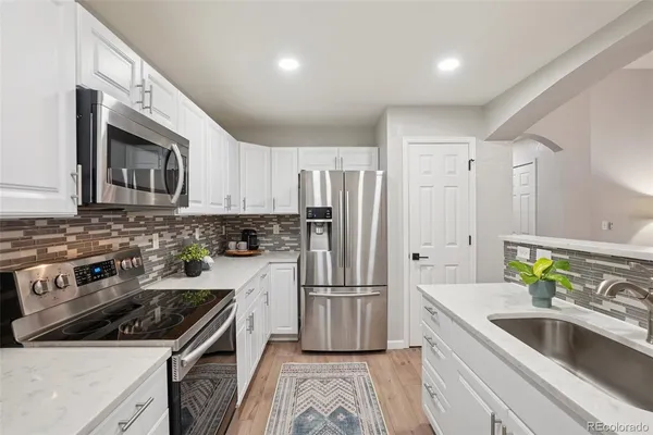 a kitchen with a sink stove and refrigerator