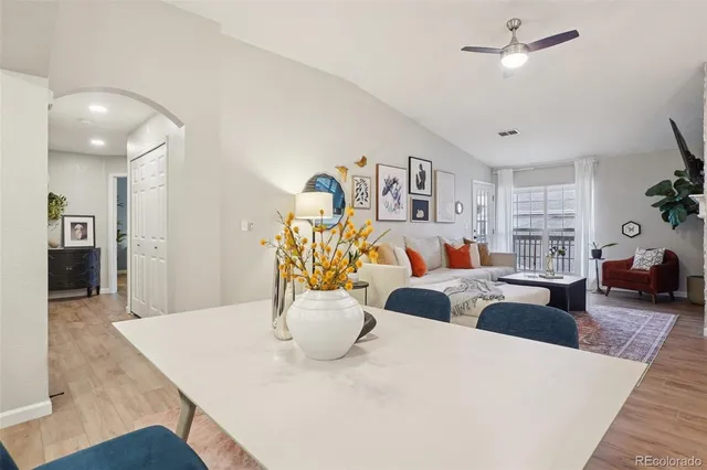 a view of a dining room with furniture and a chandelier
