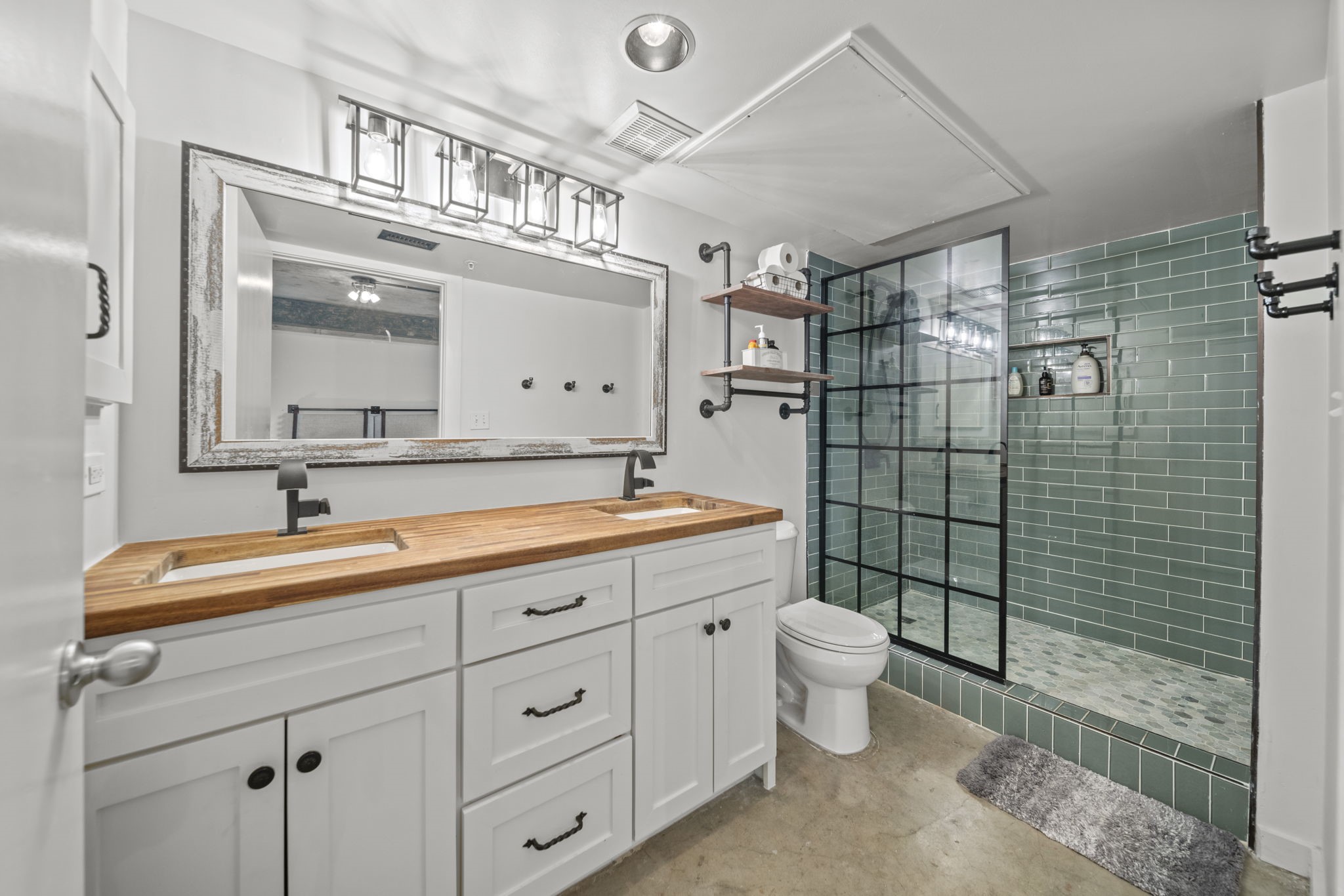 2000 Bagby Street, Unit 5417 Houston, TX 77002 - Photo 19 of 30 a bathroom with a double vanity sink mirror and toilet