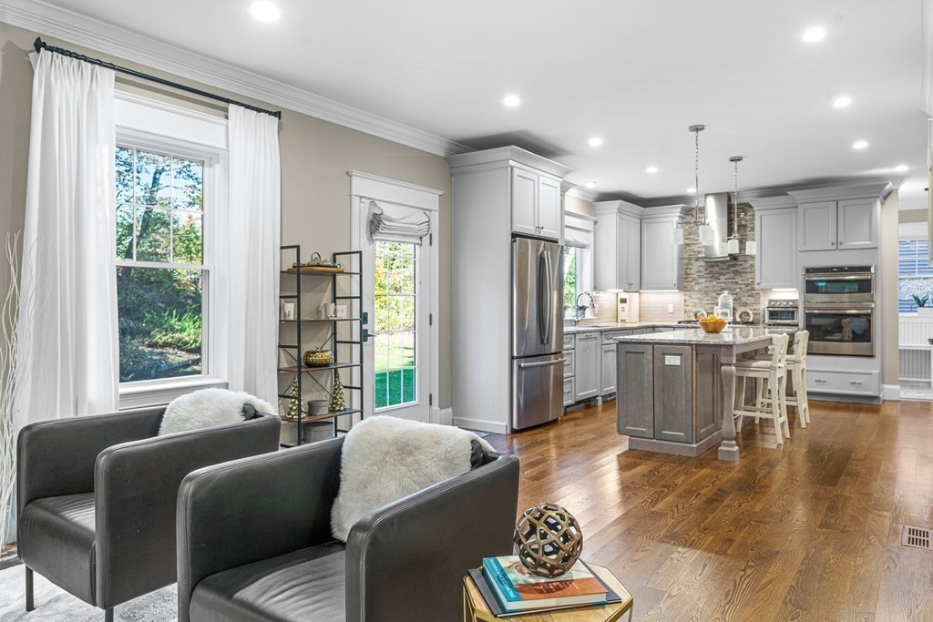 508 South Border Road Winchester, MA 01890 - Photo 11 of 41 a living room with stainless steel appliances furniture a rug and a kitchen view