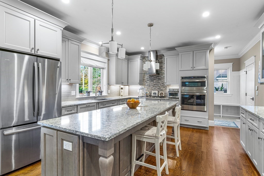 508 South Border Road Winchester, MA 01890 - Photo 14 of 41 a kitchen with stainless steel appliances granite countertop a refrigerator a stove and a wooden floors