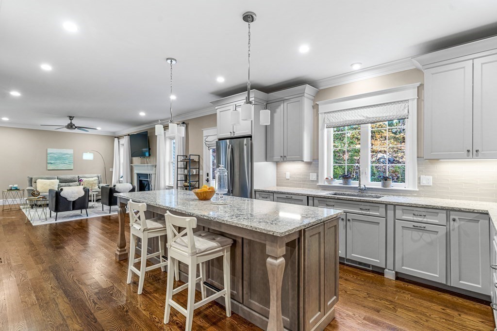 508 South Border Road Winchester, MA 01890 - Photo 16 of 41 a kitchen with stainless steel appliances granite countertop a stove a sink a oven a dining table and chairs with wooden floor