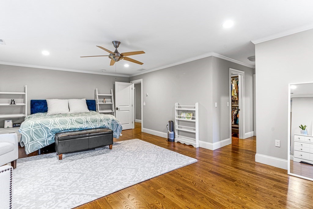 508 South Border Road Winchester, MA 01890 - Photo 20 of 41 a bedroom with a bed and a chandelier