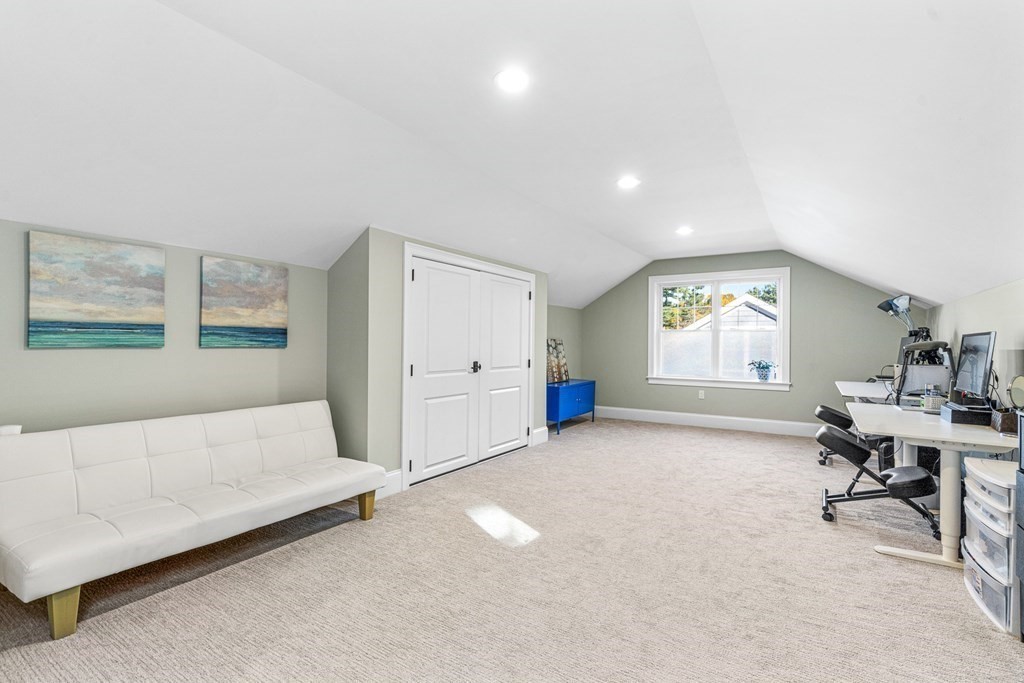 508 South Border Road Winchester, MA 01890 - Photo 29 of 41 a spacious bedroom with a bed and a table in it