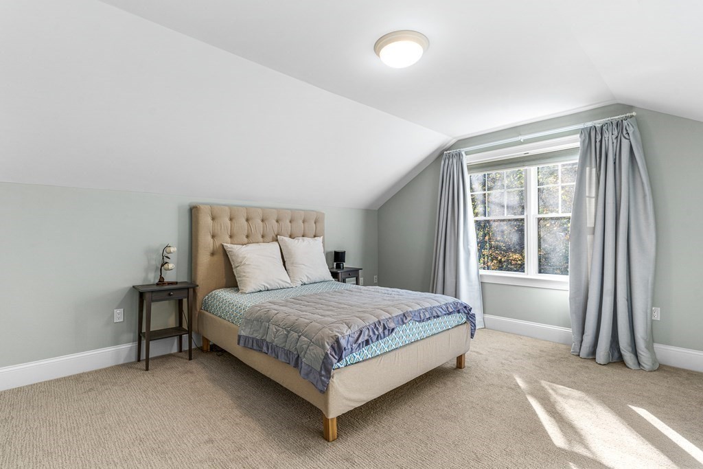 508 South Border Road Winchester, MA 01890 - Photo 30 of 41 a bed sitting in a bedroom next to a window