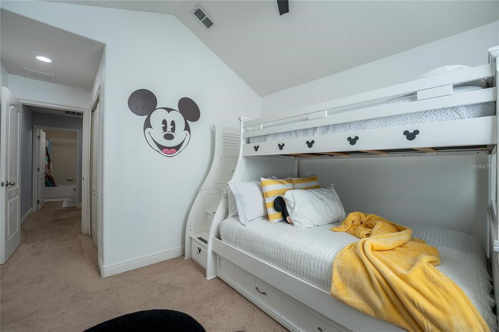 8223 Roseville Road Davenport, FL 33896 - Photo 11 of 17 a bedroom with a bed and a chandelier