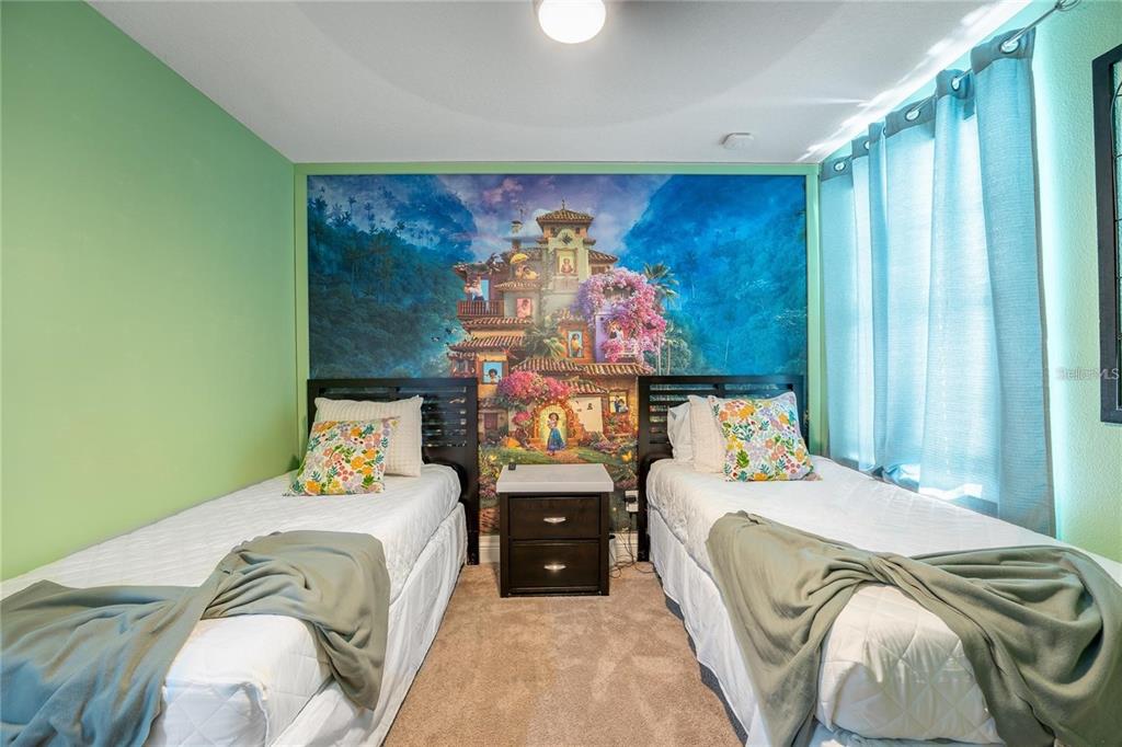 8223 Roseville Road Davenport, FL 33896 - Photo 13 of 17 a bedroom with a bed and a painting on the wall