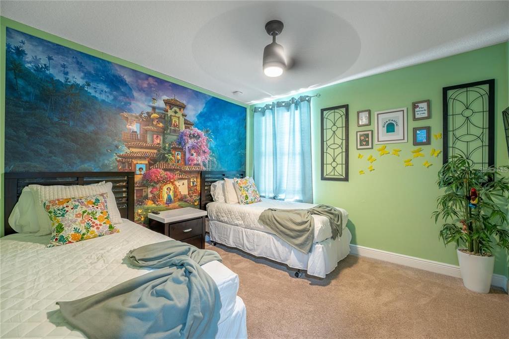 8223 Roseville Road Davenport, FL 33896 - Photo 15 of 17 a bedroom with 2 bed and a potted plant