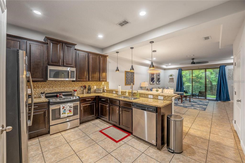 8223 Roseville Road Davenport, FL 33896 - Photo 3 of 17 a kitchen with lots of counter top space appliances and a window