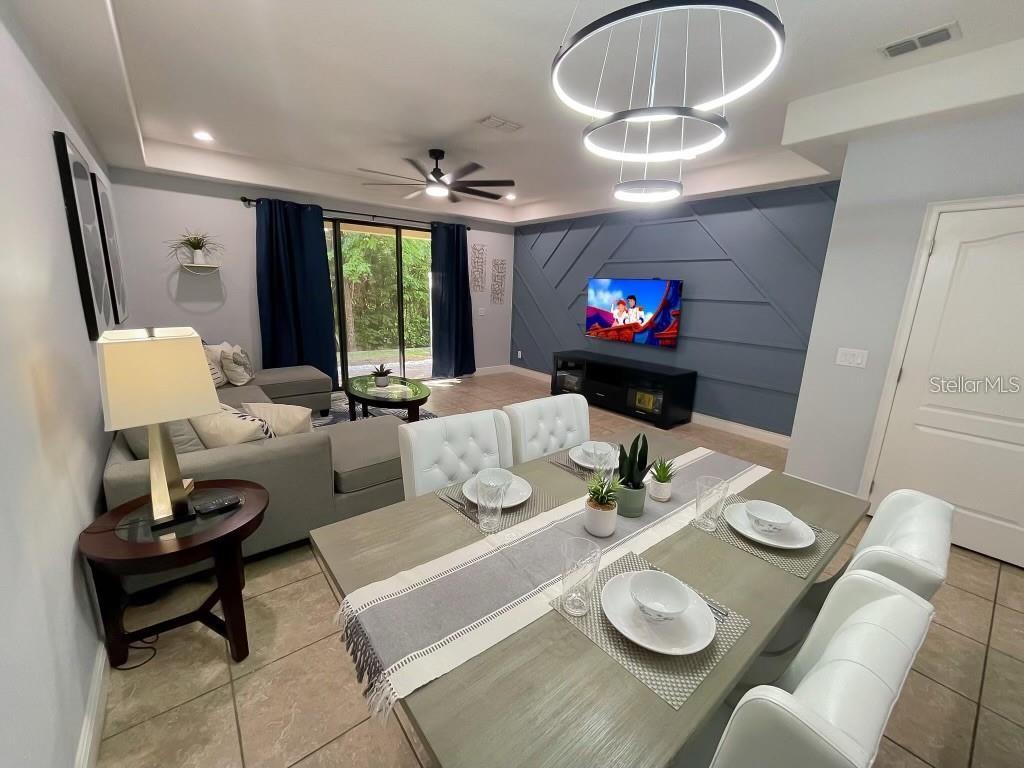 8223 Roseville Road Davenport, FL 33896 - Photo 8 of 17 a living room with furniture a window and a dining table