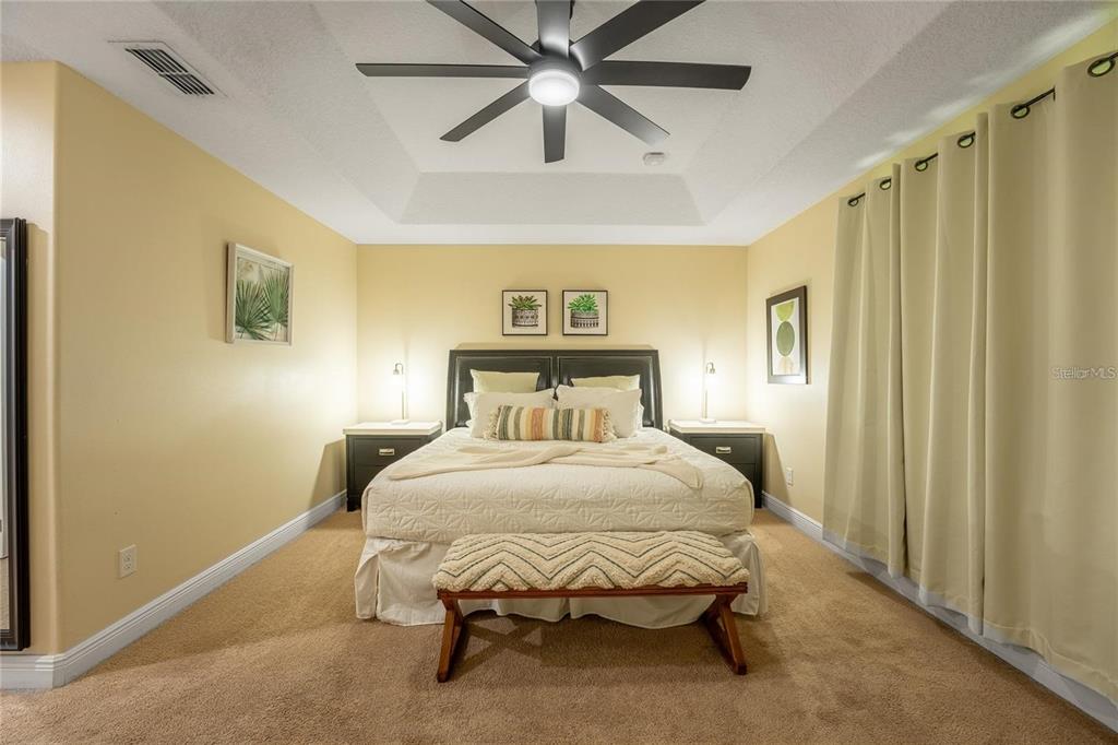 8223 Roseville Road Davenport, FL 33896 - Photo 10 of 17 a bedroom with a bed and a chandelier