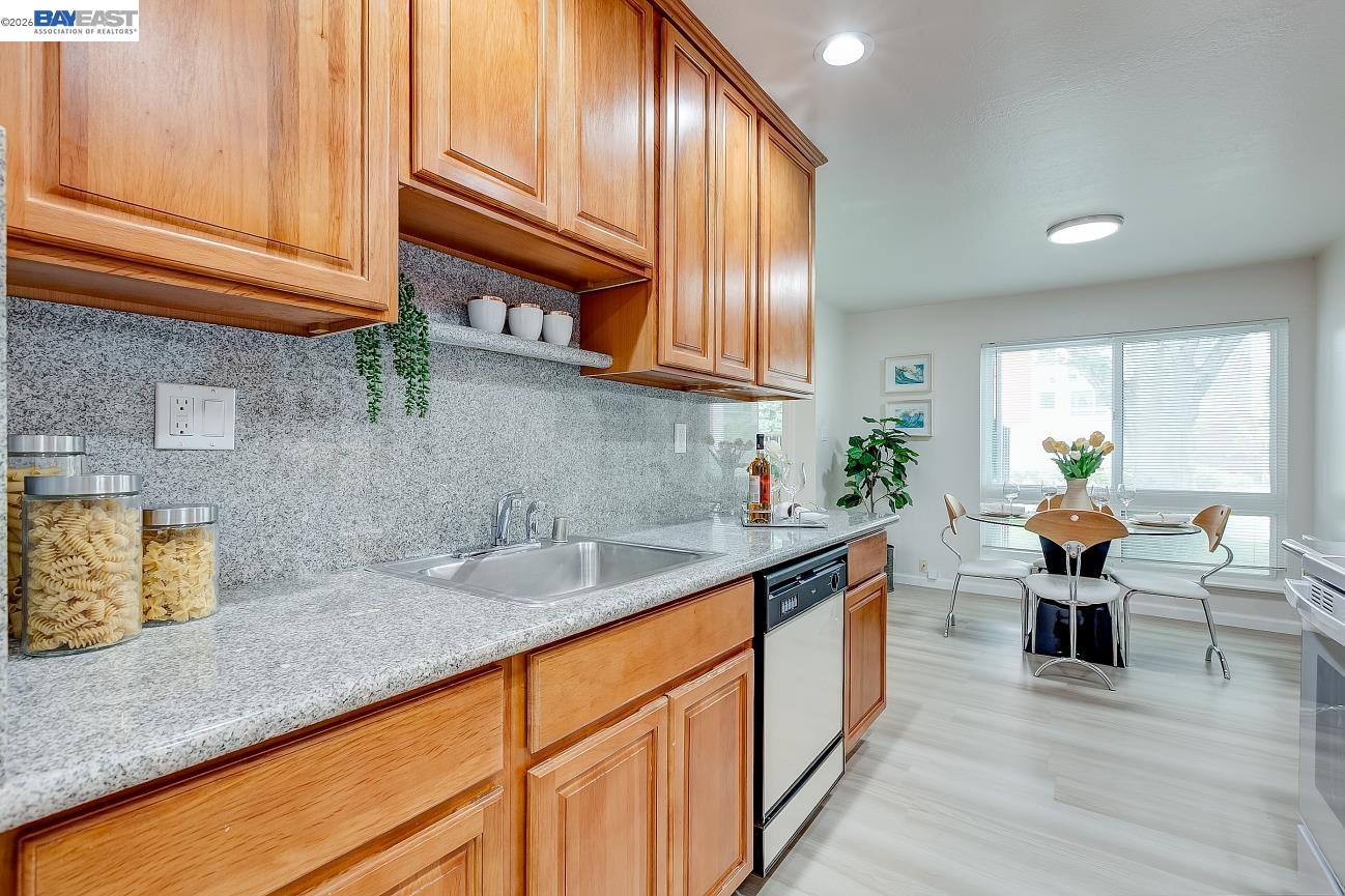 9005 Alcosta Boulevard, Unit 199 San Ramon, CA 94583 - Photo 32 of 57 a kitchen with stainless steel appliances granite countertop wooden cabinets a sink and dishwasher
