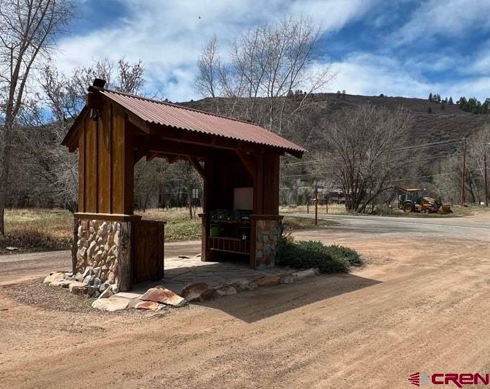31 Turtle Lake Meadows Drive Durango, CO 81301 - Photo 24 of 27 a view of a barn with wooden wall next to a yard