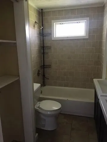 a bathroom with a toilet and a bath tub