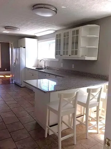 a kitchen with stainless steel appliances granite countertop a stove a sink and a microwave