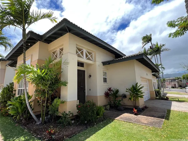 a front view of a house with garden