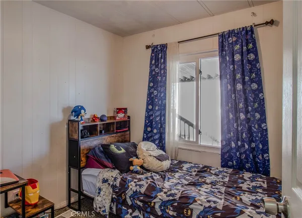 a bed room with a bed and a chair