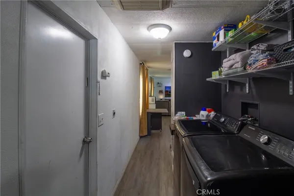 a kitchen view of a sink and a refrigerator