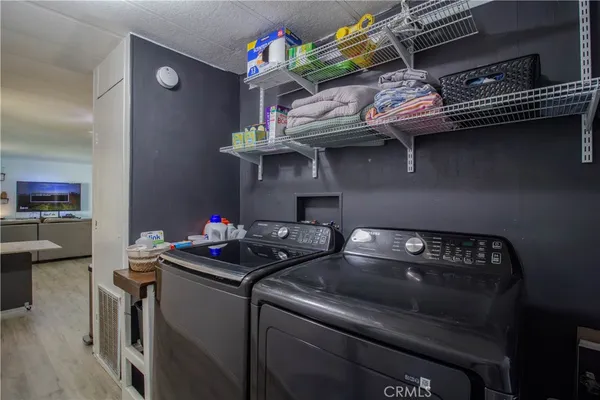 a kitchen with a stove and a wooden floor