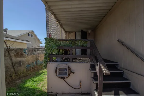 a view of house with backyard and glass windows