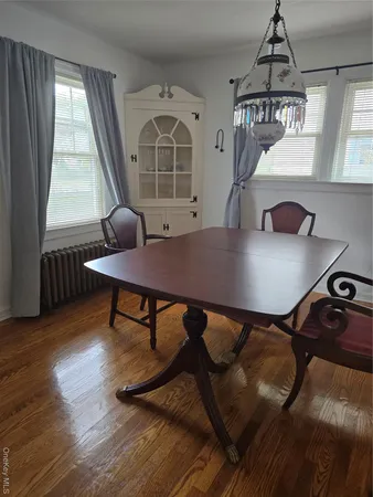a view of a workspace with furniture window and wooden floor