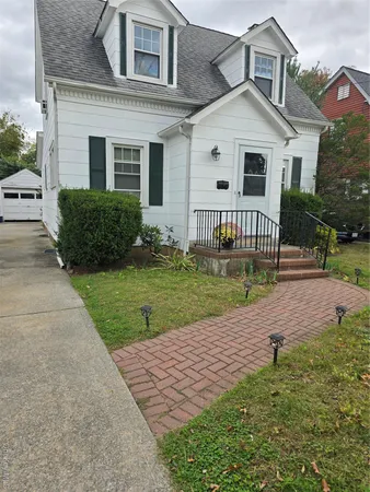 a view of a white house with a yard