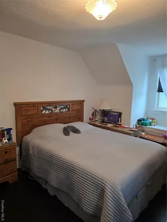 a bedroom with a bed and a lamp