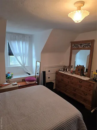 a bedroom with a bed and a dresser