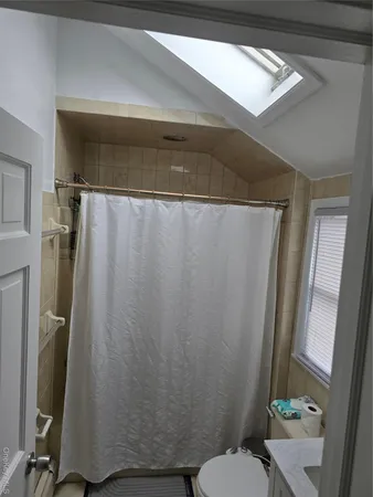 a bathroom with a shower curtain and a toilet