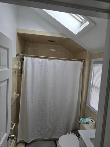 a bathroom with a shower curtain and a toilet