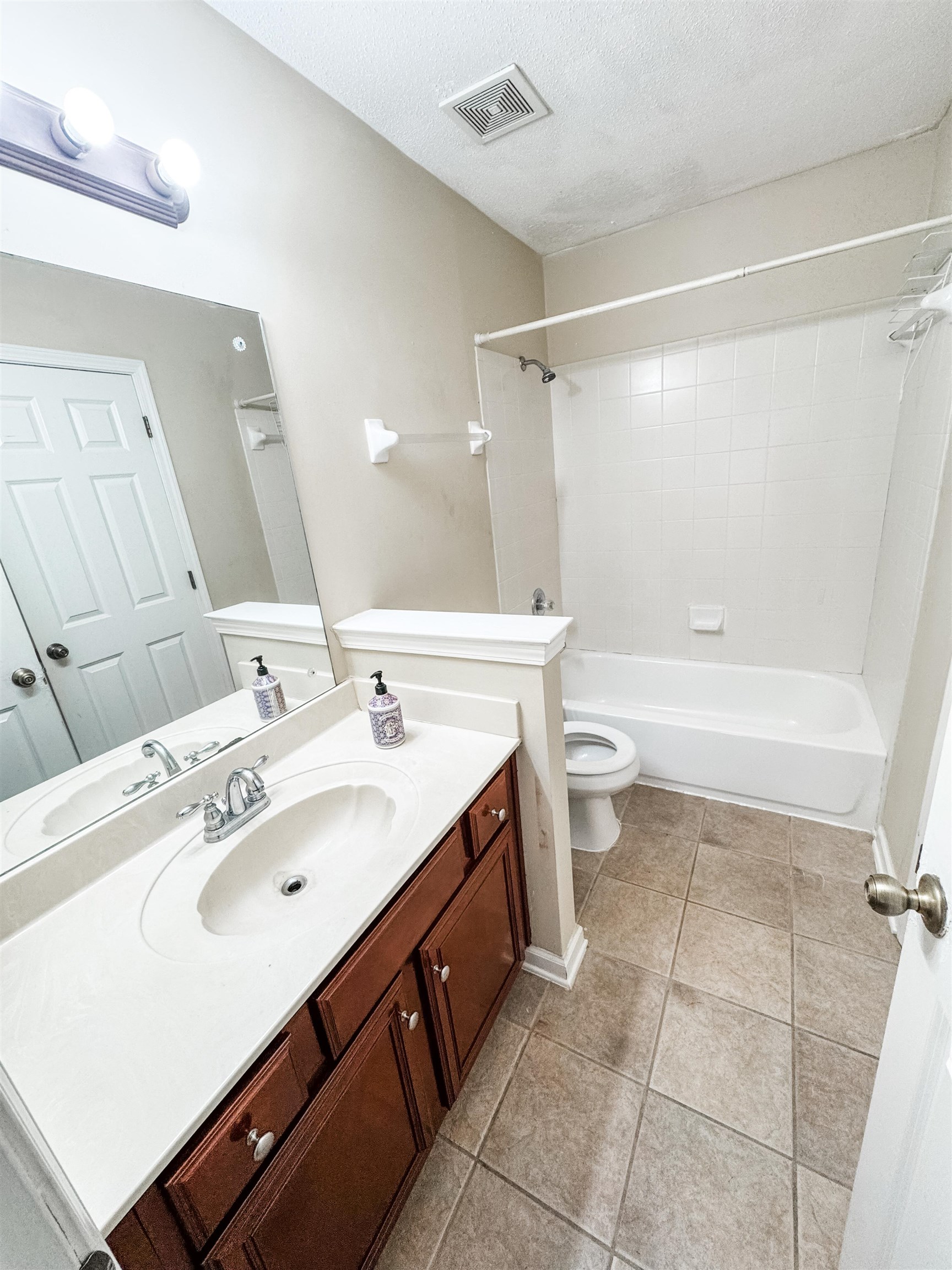 10431 Pilot Rock Road Collierville, TN 38017 - Photo 12 of 15 Full bathroom with tile patterned floors, a textured ceiling, toilet, shower / tub combination, and vanity