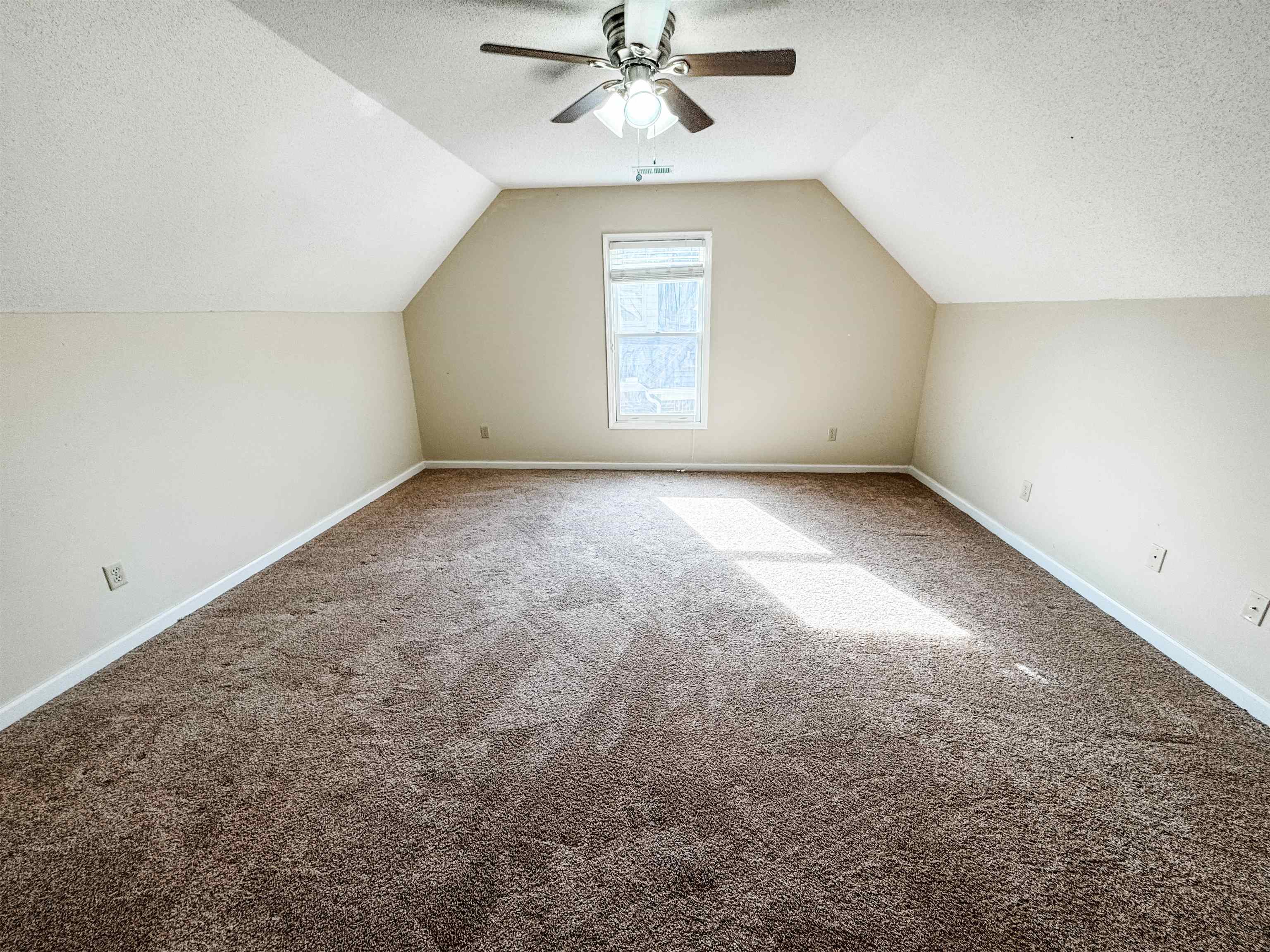 10431 Pilot Rock Road Collierville, TN 38017 - Photo 15 of 15 Additional living space with carpet flooring, ceiling fan, a textured ceiling, and vaulted ceiling