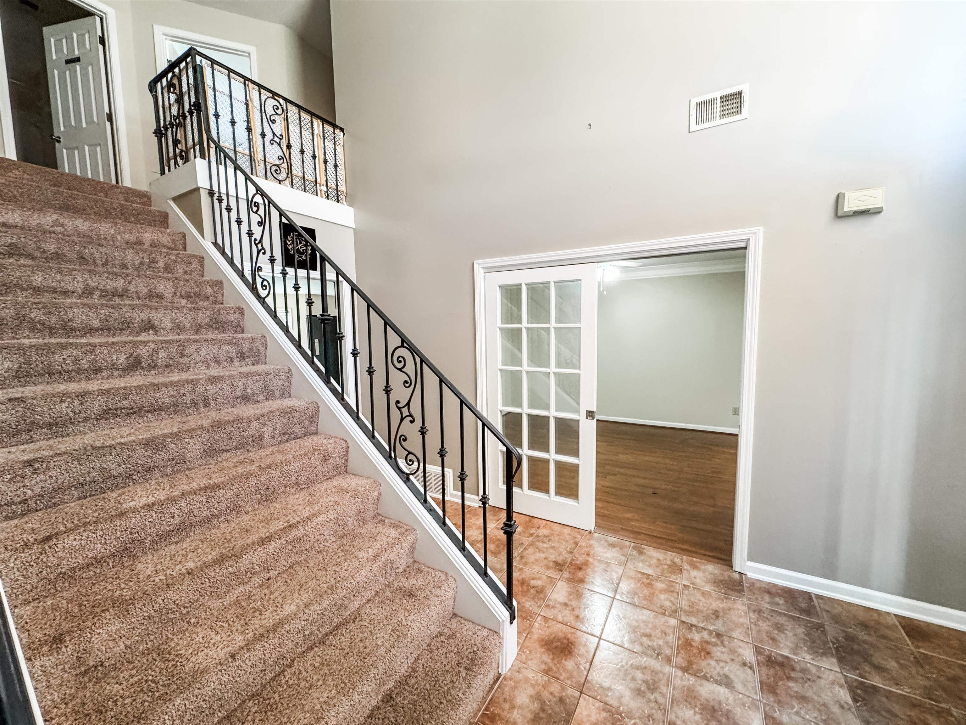 10431 Pilot Rock Road Collierville, TN 38017 - Photo 3 of 15 Stairs featuring wood-type flooring, french doors, and a high ceiling