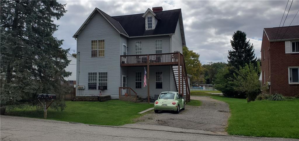 1426 Homestead Road Verona, PA 15147 - Photo 1 of 25 a view of a house with a small yard and plants