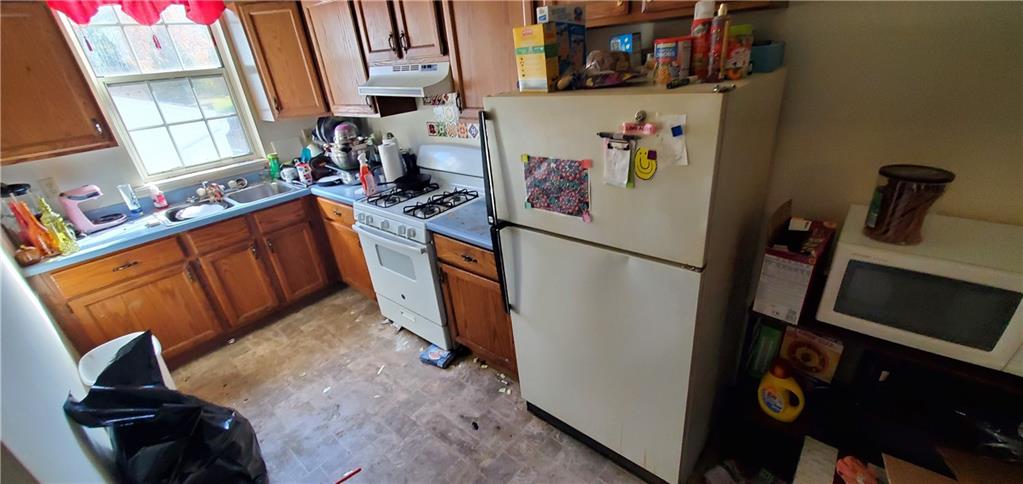 1426 Homestead Road Verona, PA 15147 - Photo 9 of 25 a view of a kitchen with fridge and workspace