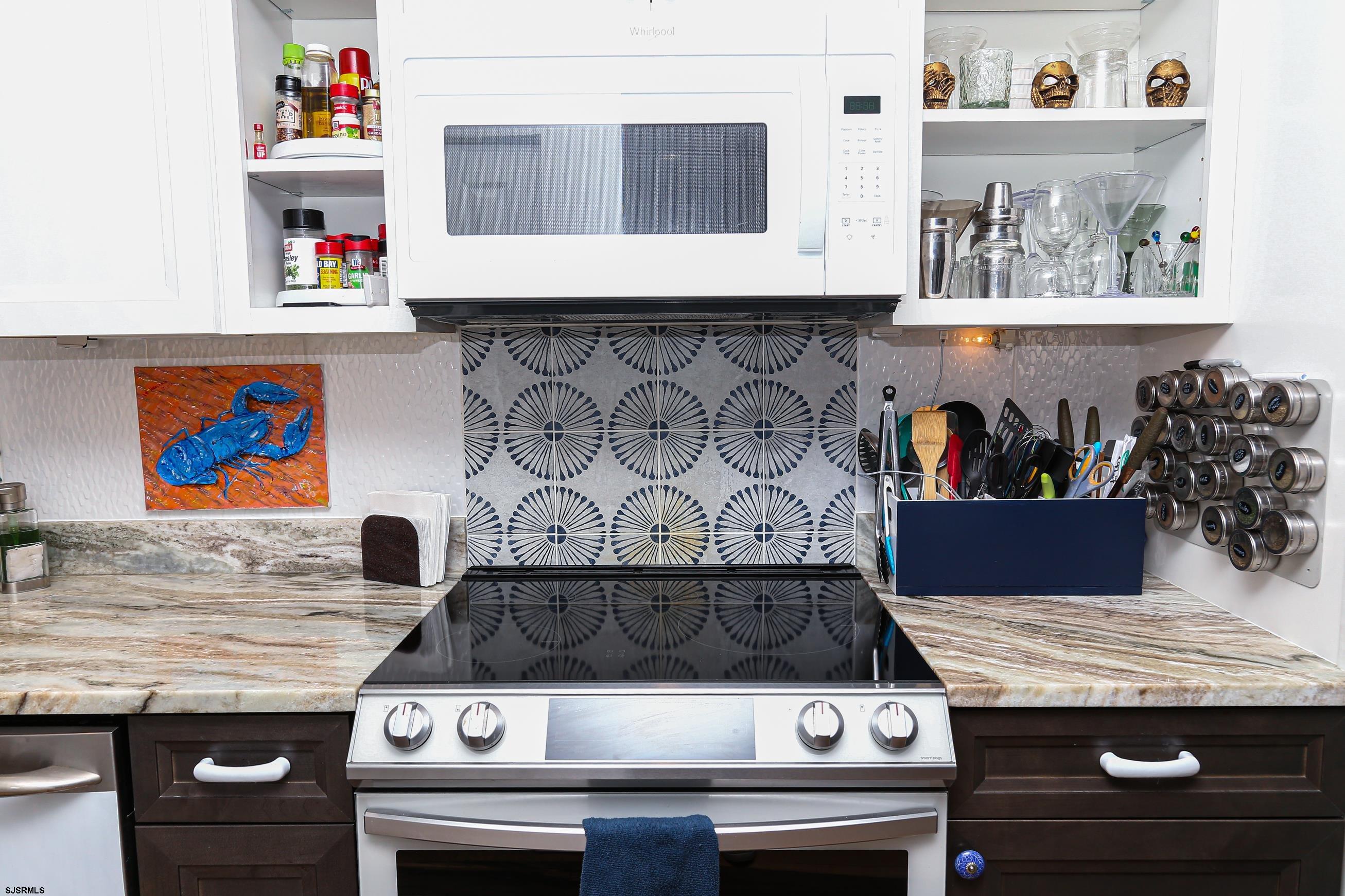 401 37th Street South, Unit 5 Brigantine, NJ 08203 - Photo 11 of 48 a stove top oven sitting inside of a kitchen