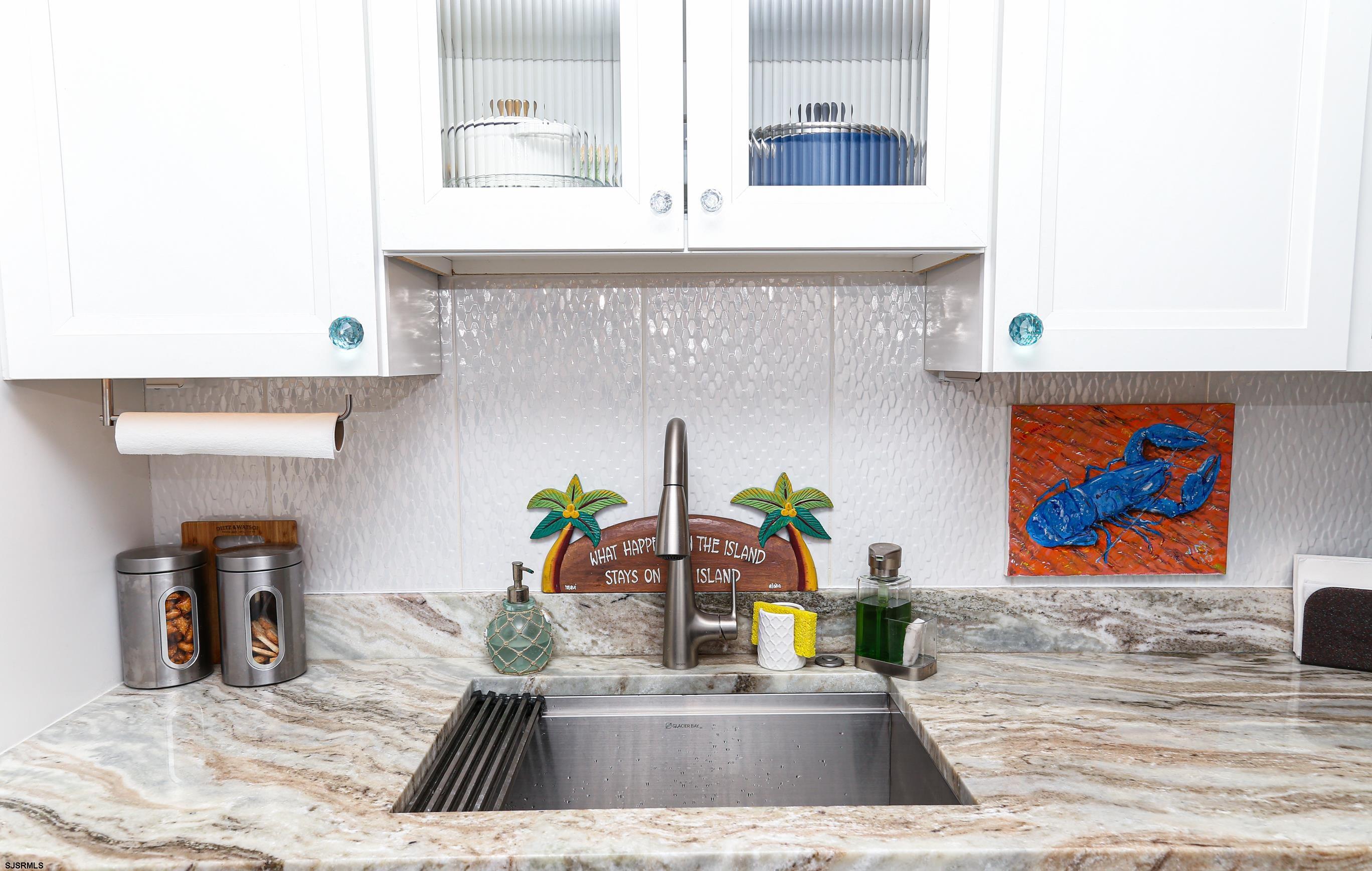 401 37th Street South, Unit 5 Brigantine, NJ 08203 - Photo 13 of 48 a kitchen with stainless steel appliances a counter top space and cabinets