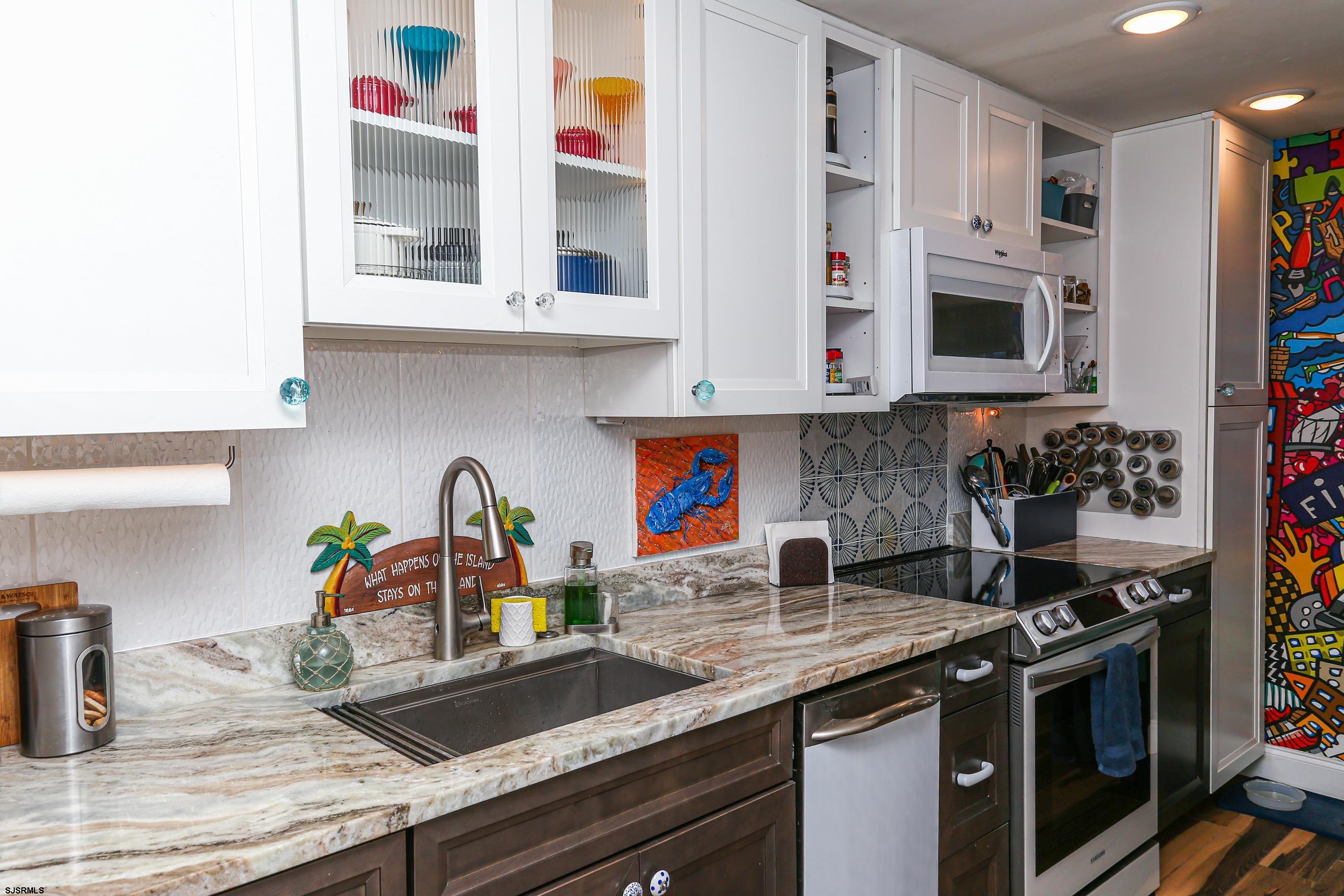 401 37th Street South, Unit 5 Brigantine, NJ 08203 - Photo 15 of 48 a kitchen with stainless steel appliances granite countertop a sink and a stove