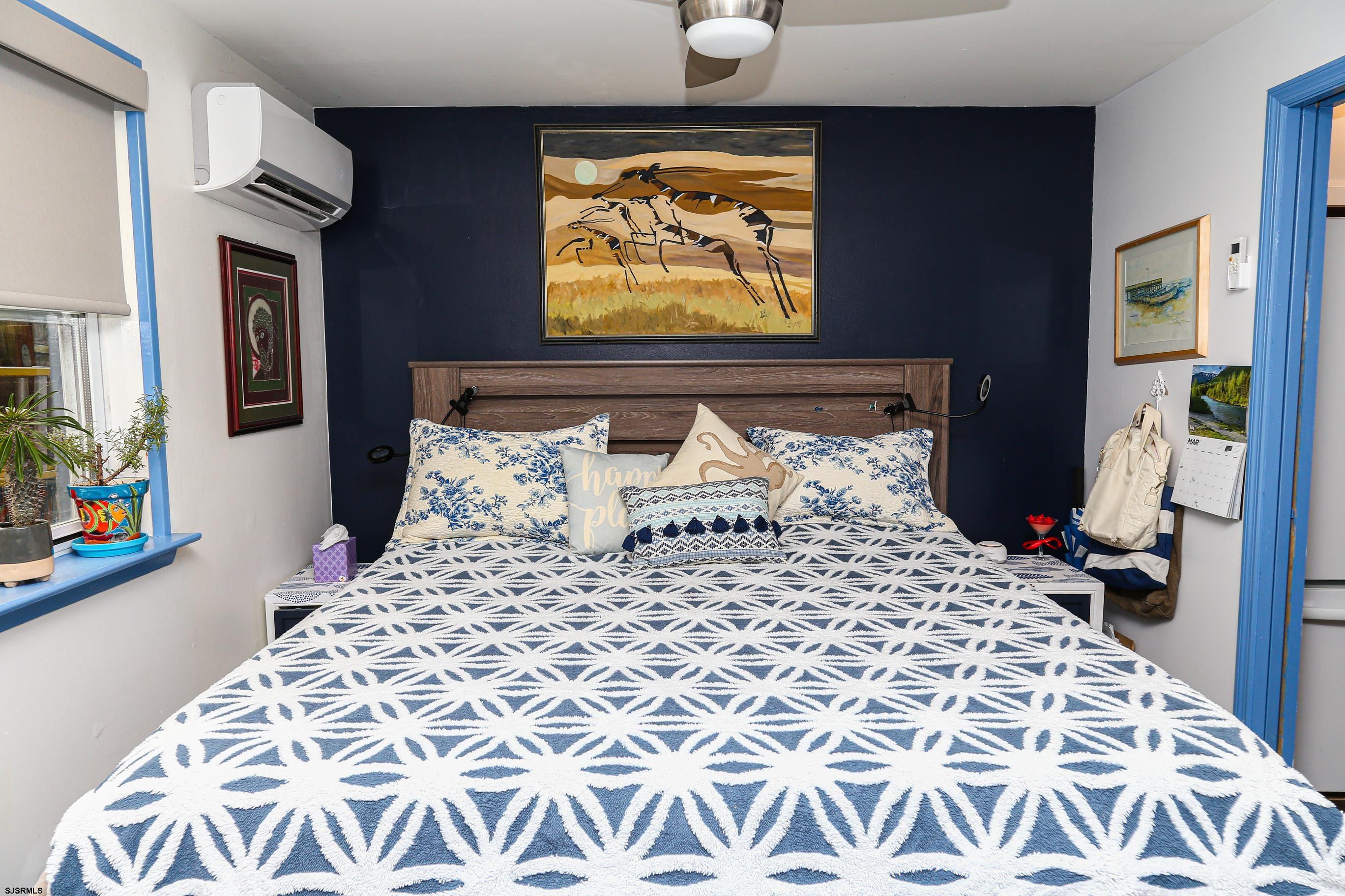 401 37th Street South, Unit 5 Brigantine, NJ 08203 - Photo 23 of 48 a large bed sitting in a bedroom next to a window