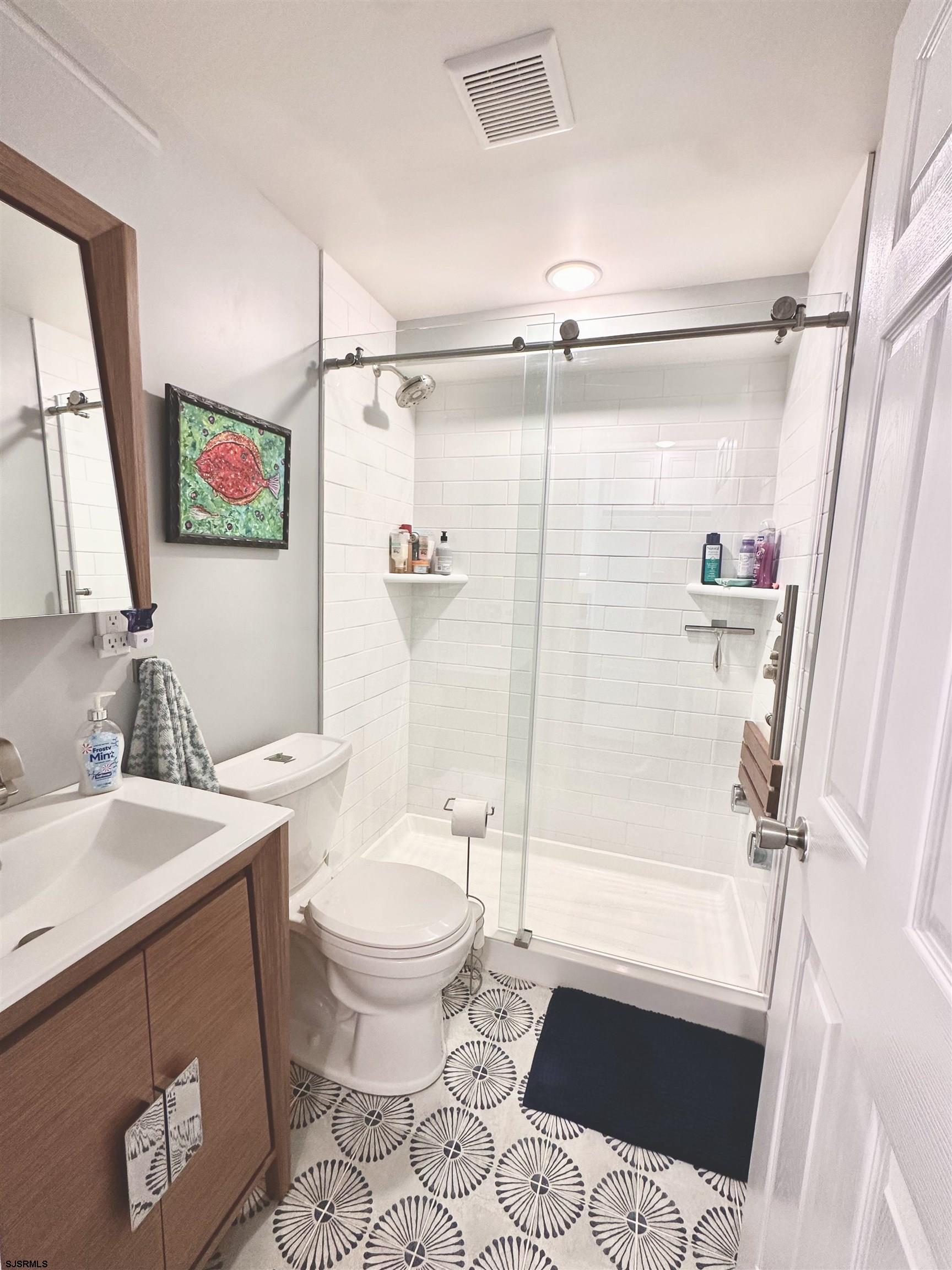 401 37th Street South, Unit 5 Brigantine, NJ 08203 - Photo 27 of 48 a bathroom with a sink toilet and shower