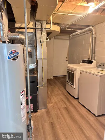 a view of storage and utility room with washer and dryer