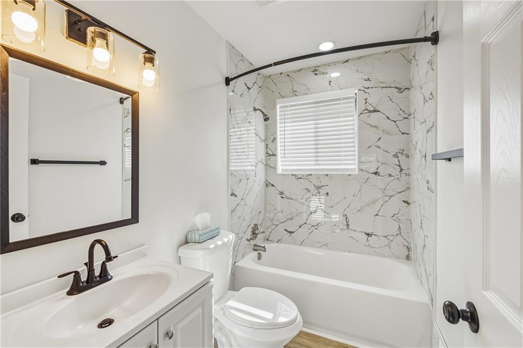 3822 Stephanie Drive Southwest Atlanta, GA 30331 - Photo 11 of 28 a bathroom with a bathtub shower sink vanity and toilet