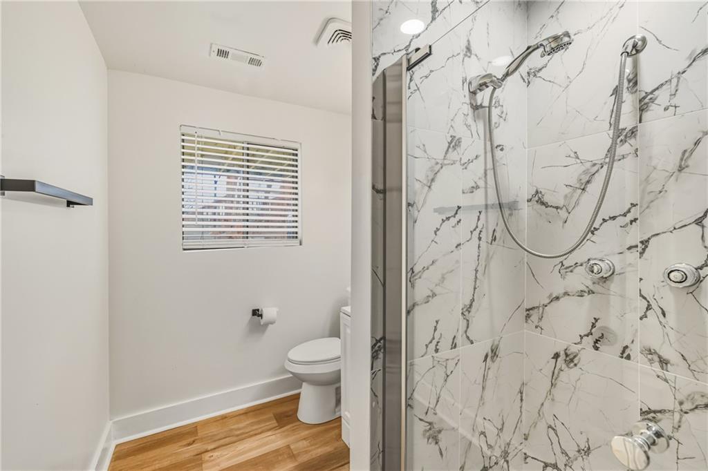 3822 Stephanie Drive Southwest Atlanta, GA 30331 - Photo 17 of 28 a bathroom with a toilet and shower curtain