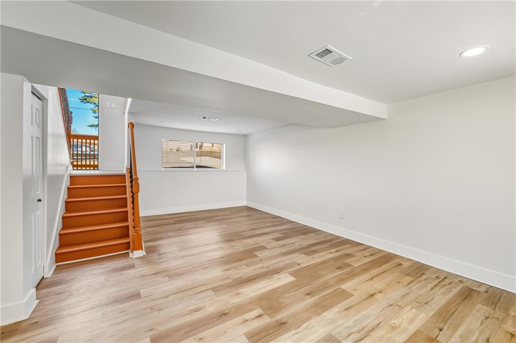 3822 Stephanie Drive Southwest Atlanta, GA 30331 - Photo 22 of 28 an empty room with wooden floor and windows