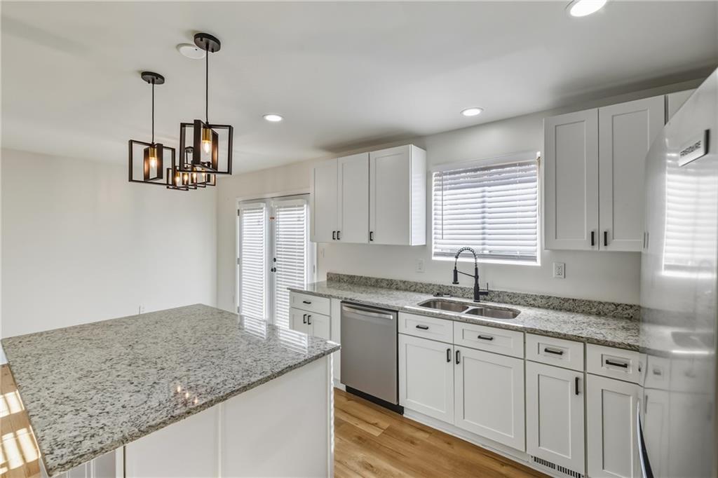 3822 Stephanie Drive Southwest Atlanta, GA 30331 - Photo 6 of 28 a kitchen with kitchen island granite countertop a sink a counter space appliances and cabinets